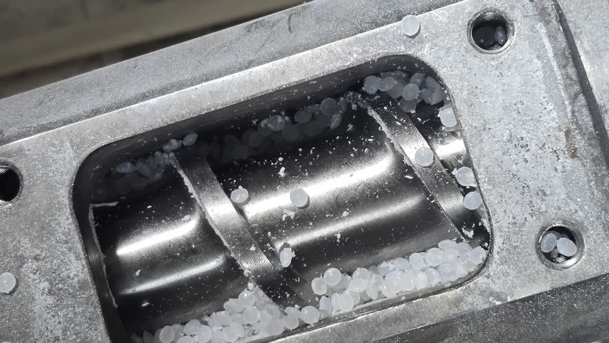 LLDPE resin pellets in the extruder feed